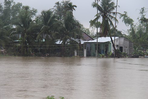 Một căn nhà ở ven sông Cái bị ngập trong nước lũ