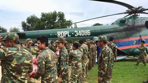 Lực lượng cứu hộ vận chuyển lương thực lên trực thăng để đưa đến tỉnh Attapeu hôm 24/7. Ảnh: BBC.