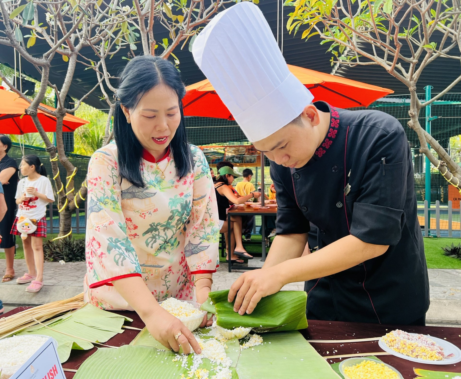 Champa Island staff teaching participants to wrap Tet cakes

