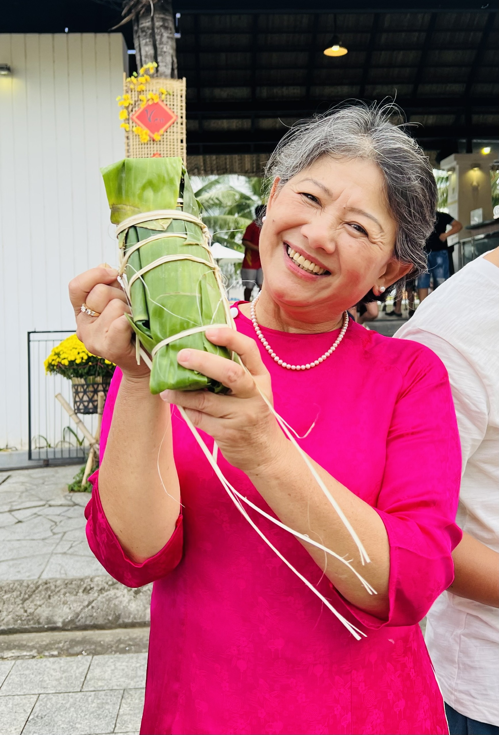 A female participant is happy with her Tet cake

