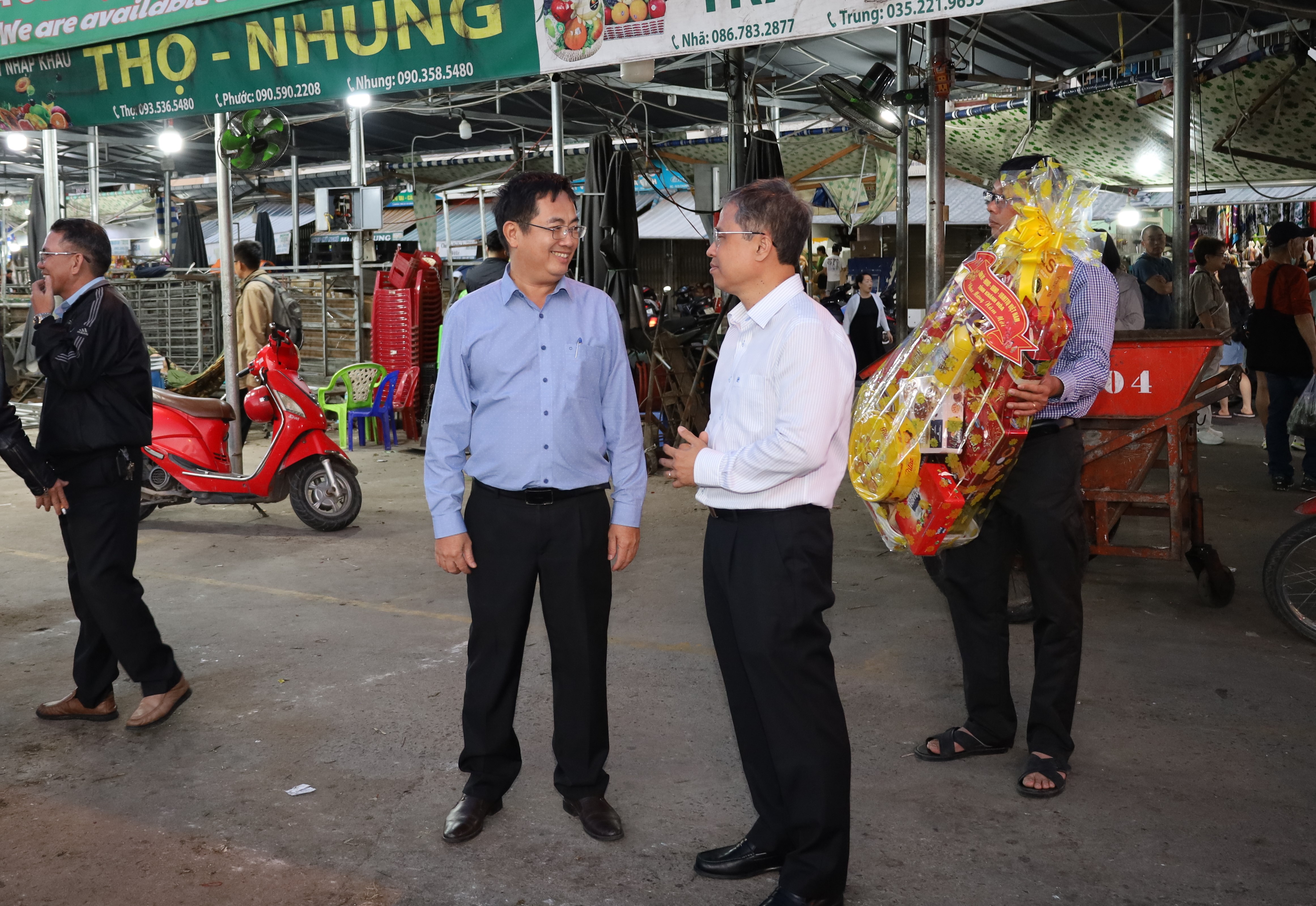 Ông Trần Hòa Nam (bìa phải) trao đổi với lãnh đạo đơn vị về phương án thu gom, vận chuyển rác thải trong đêm giao thừa.