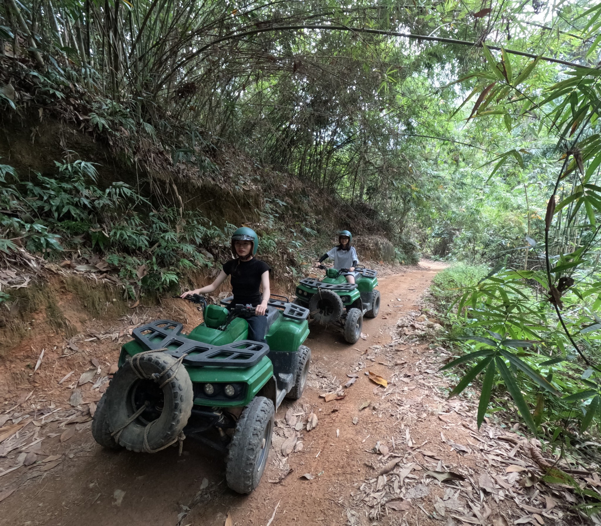 Guests on a tour through the forest by ATV in Kong Forest.