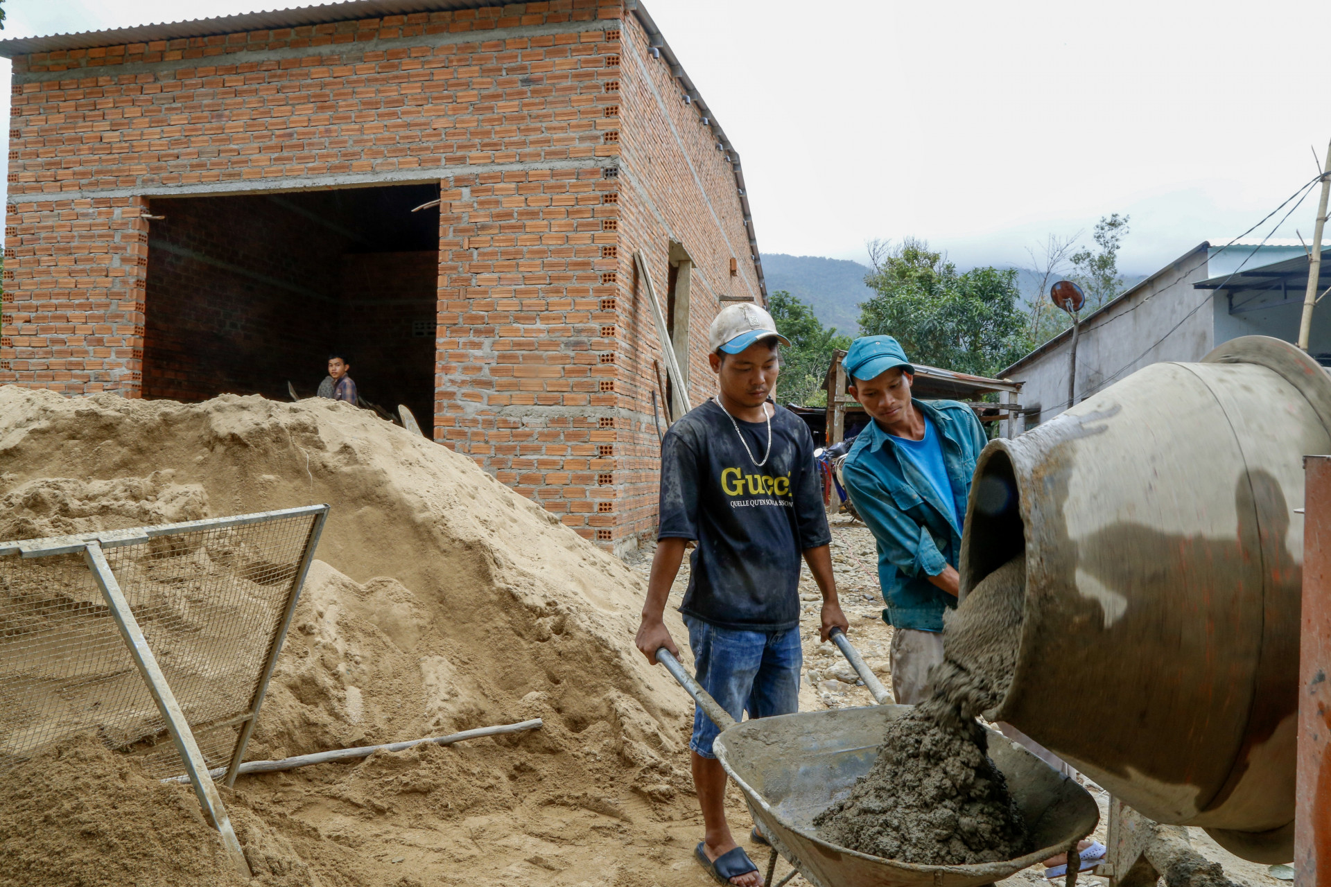 A poor household in Son Trung commune receives support to build house.