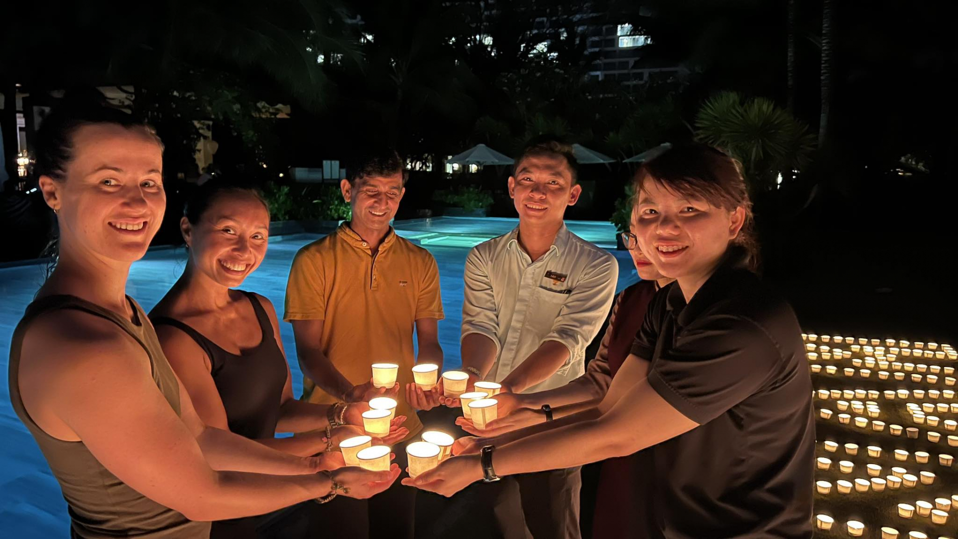 Staff and visitors at The Anam join hands to light candles to spread the message of saving energy, contributing to environmental protection.