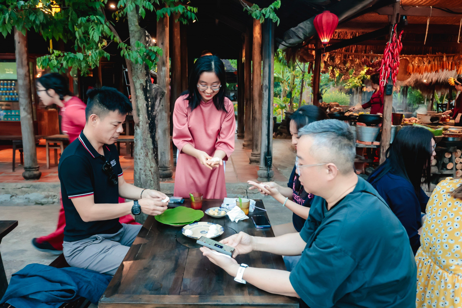 Tourists making banh it at 