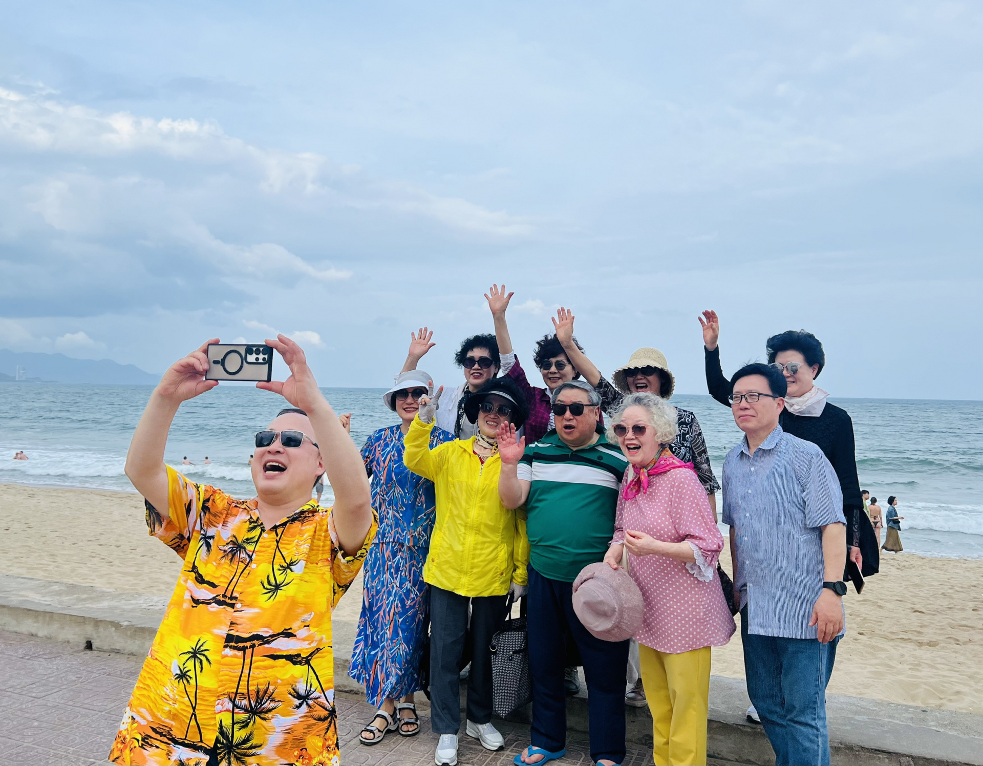 Korean tourists take photo on Nha Trang beach.