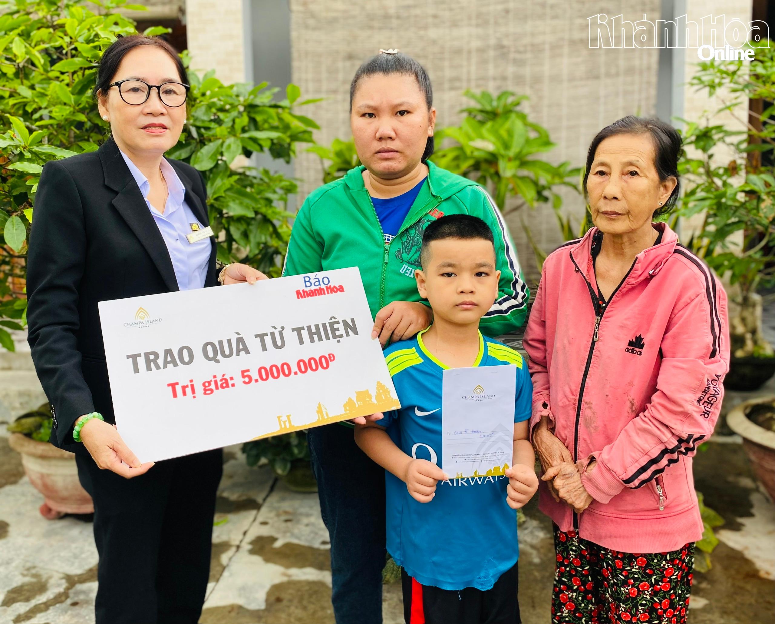 Đại diện Công ty Cổ phần Đầu tư Champagroup - Khu du lịch Champa Island Nha Trang trao tiền ủng hộ cho gia đình cháu Nguyễn Hoàng Bách
