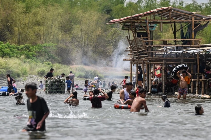 Người dân tắm sông tránh nóng tại Bulacan (Philippines) ngày 6-4-2024. Ảnh: AFP/TTXVN
