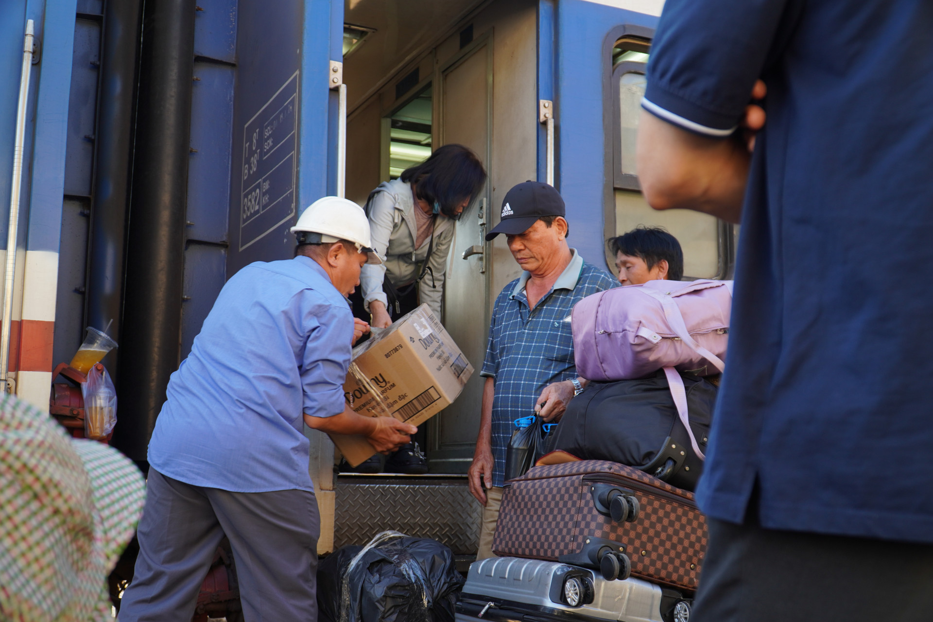 Nhân viên Ngành đường sắt hỗ trợ khách hàng di chuyển hành lý từ tàu qua xe trung chuyển