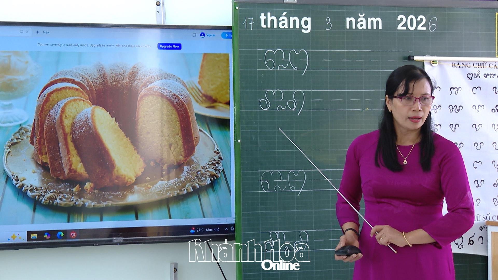 Giáo viên hướng dẫn học sinh viết chữ Chăm, kết hợp trình chiếu hình ảnh minh họa trong giờ học.