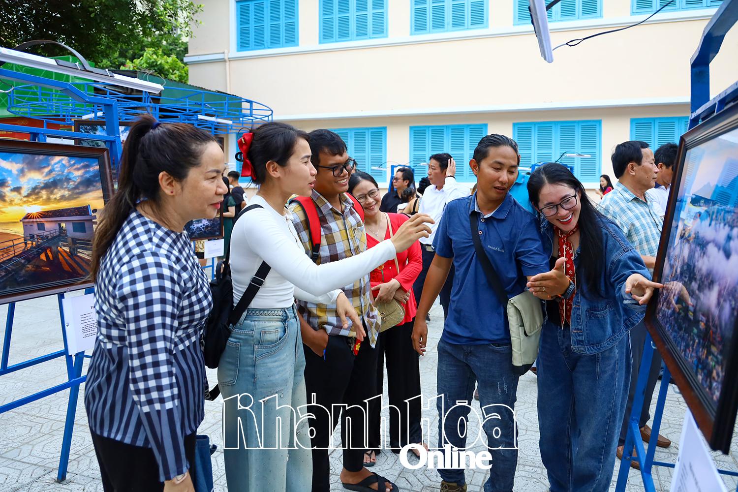 People viewing photos at the exhibition

