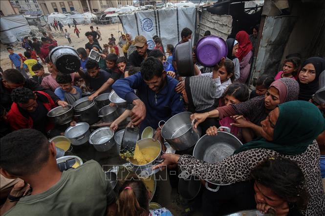 Người dân Palestine chờ được phát thực phẩm cứu trợ tại Gaza ngày 12/5/2025. Ảnh: THX/TTXVN