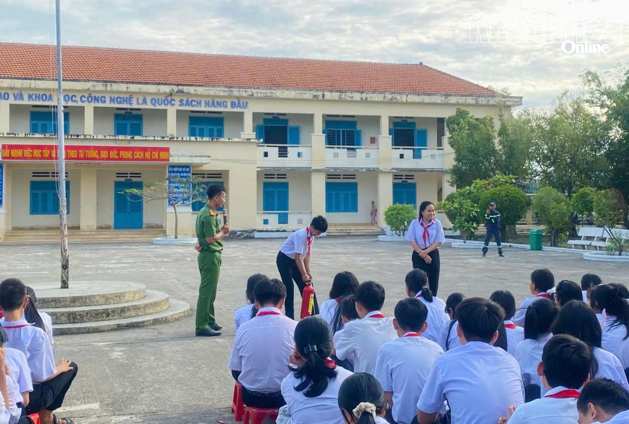 Các em học sinh được tìm hiểu, làm quen với bình chữa cháy xách tay.