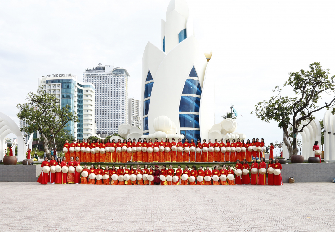 Women wearing Ao Dai with the images of star and Vietnam’s map posing for photo by Tram Huong Tower

