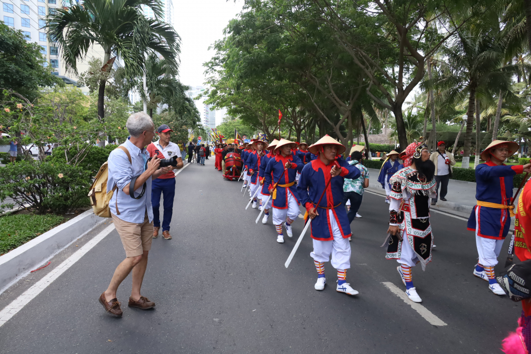 Foreign taking photos of ritual procession
