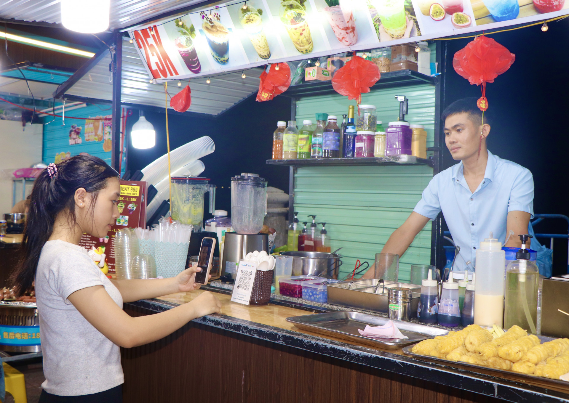 Chị Nguyễn Khánh Ngân (phường Vĩnh Hòa, TP. Nha Trang) quét mã QR để thanh toán hoá đơn tại Chợ đêm Nha Trang.