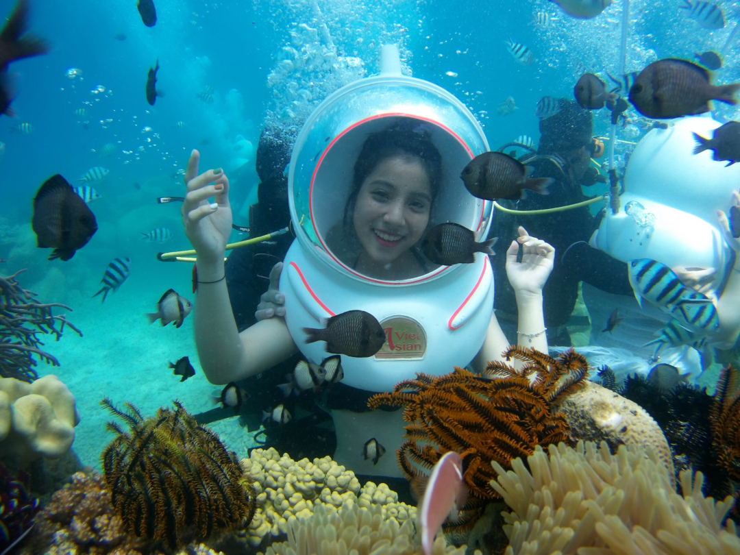 Posing with coral reefs and fish

