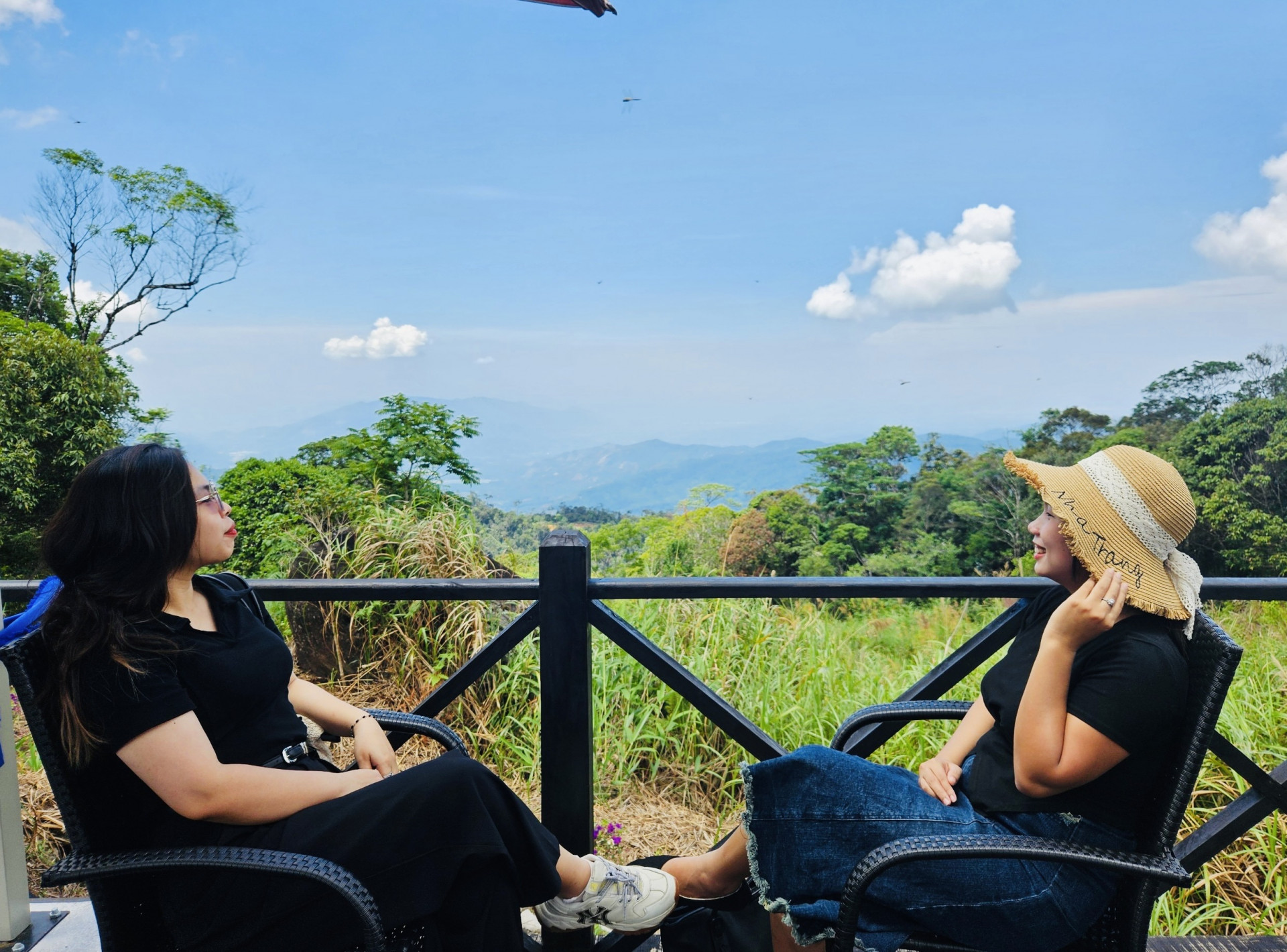 Tourists contemplate landscape in Hon Ba.