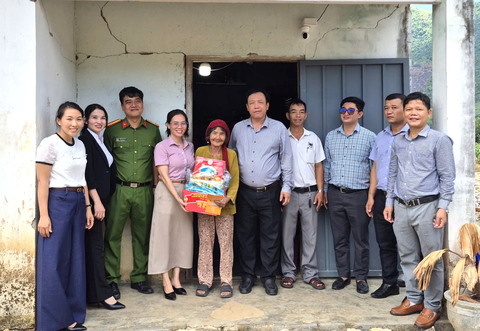 Đại diện lãnh đạo xã tặng quà cho bà Cao Thị Sính.