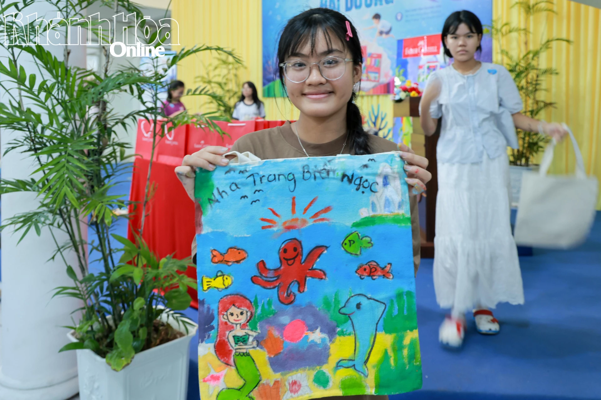 Một bạn nhỏ vui tươi bên tác phẩm của mình.