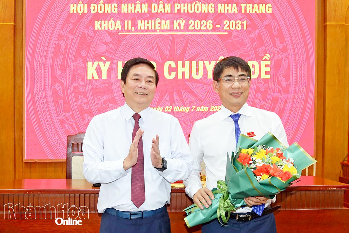 Đồng chí Lữ Thanh Hải tặng hoa chúc mừng ông Trần Xuân Tây được bầu giữ chức vụ Chủ tịch HĐND phường.