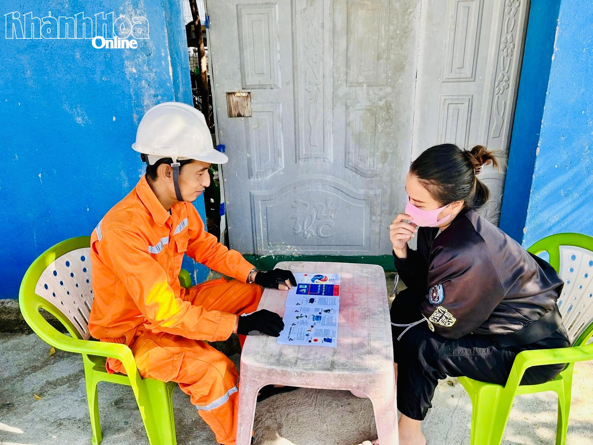Nhân viên Công ty Điện lực Khánh Hòa hướng dẫn khách hàng sử dụng các dịch vụ điện trực tuyến và thanh toán không dùng tiền mặt.