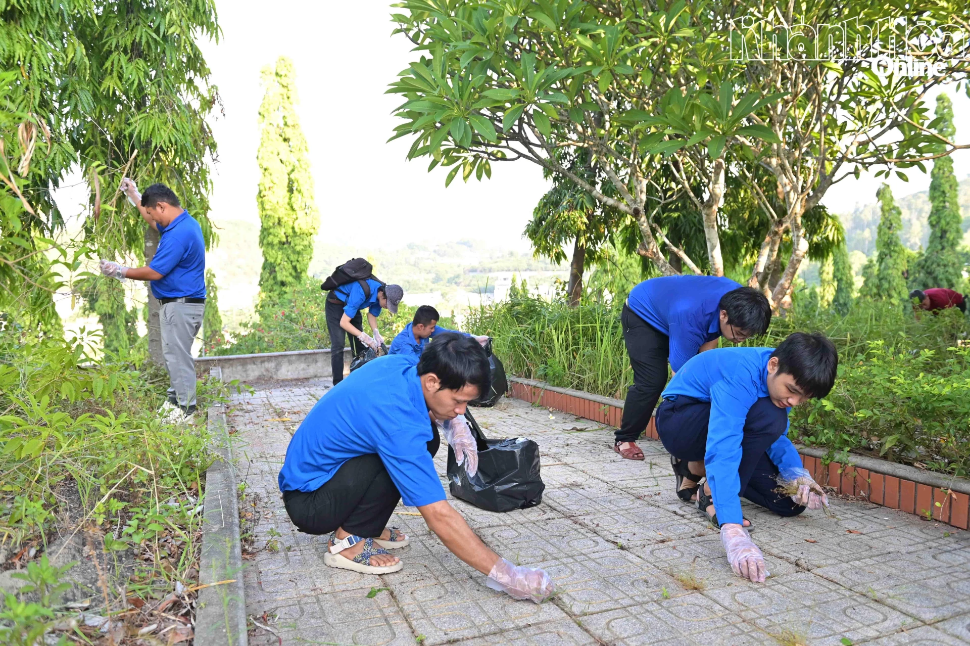 Các đoàn viên, thanh niên vệ sinh các lối đi trong nghĩa trang liệt sĩ.