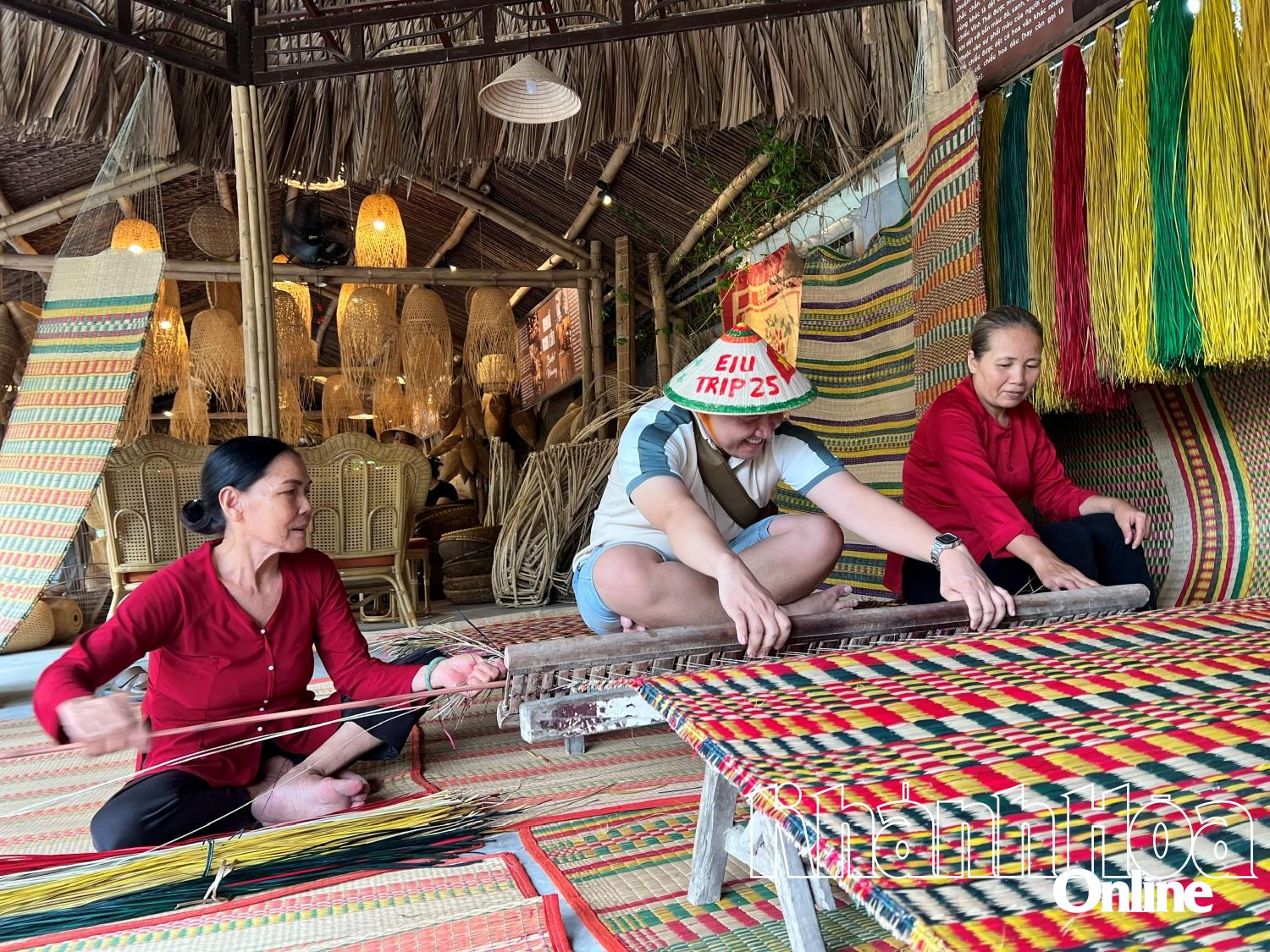 A Russian tourist experiencing mat weaving at Nha Trang Xua Traditional Village

