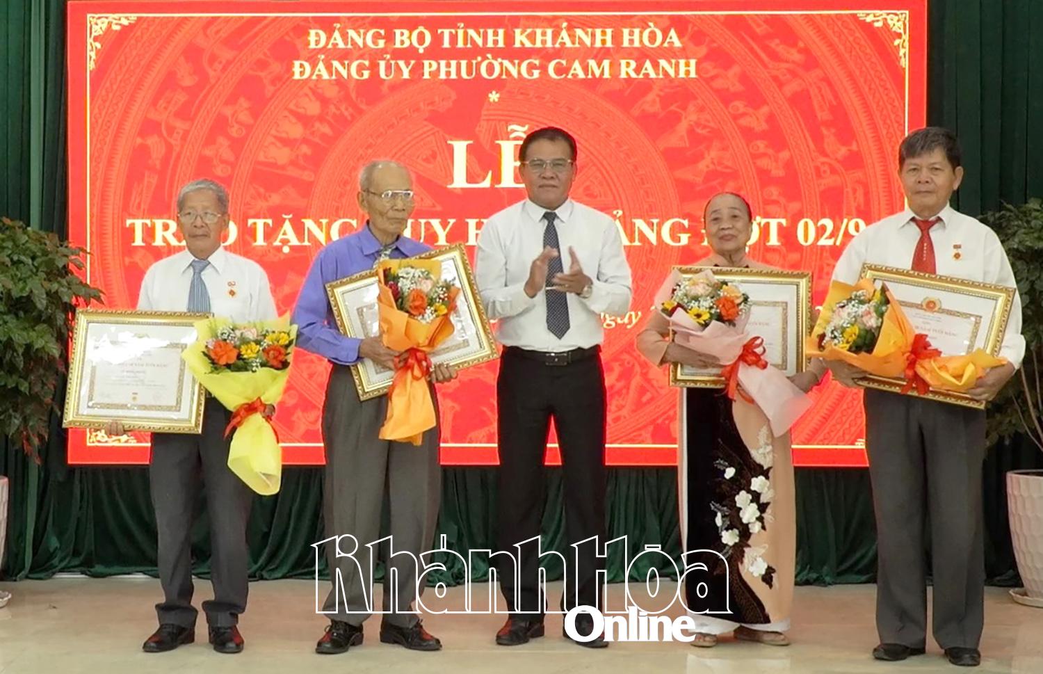 Đồng chí Lê Ngọc Thạch - Bí thư Đảng ủy phường Cam Ranh trao tặng Huy hiệu 50 năm tuổi Đảng cho các đảng viên.