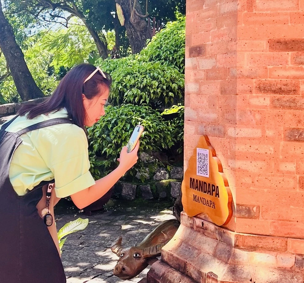 Tourists scan QR codes at the special national relic Po Nagar Tower.