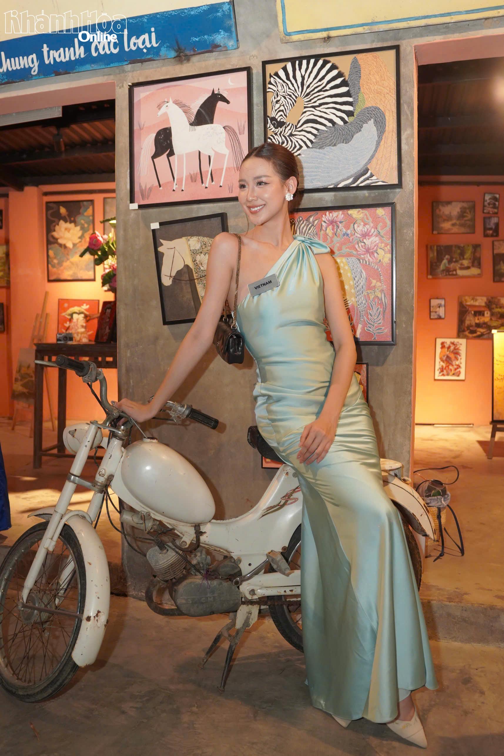 Miss World Vietnam Le Nguyen Bao Ngoc poses with vintage motorcycle