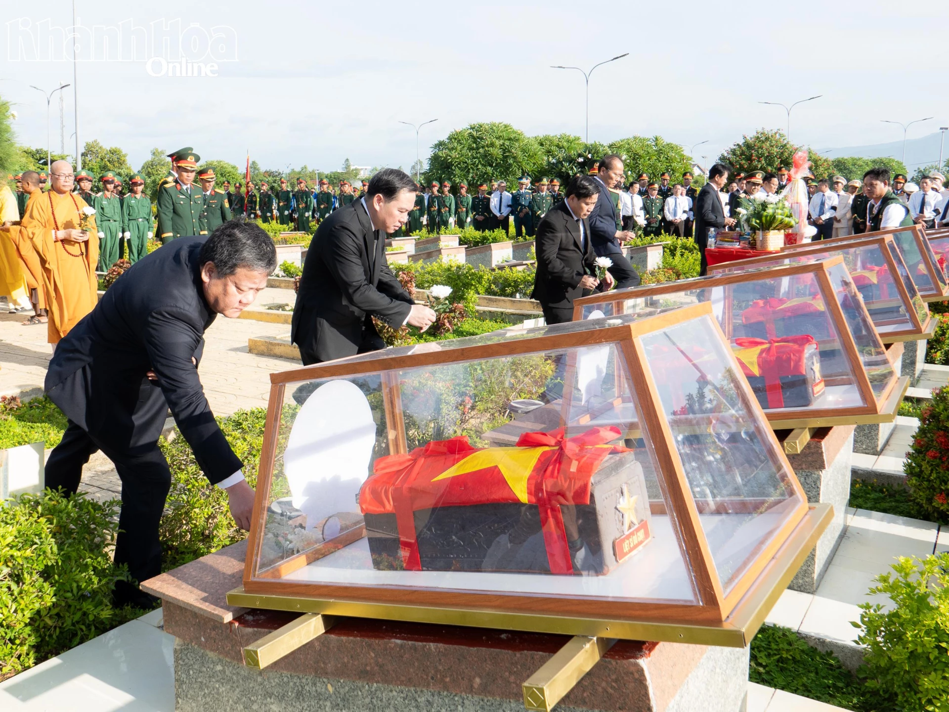 Các đại biểu đặt hoa trước lúc an táng các hài cốt liệt sĩ.