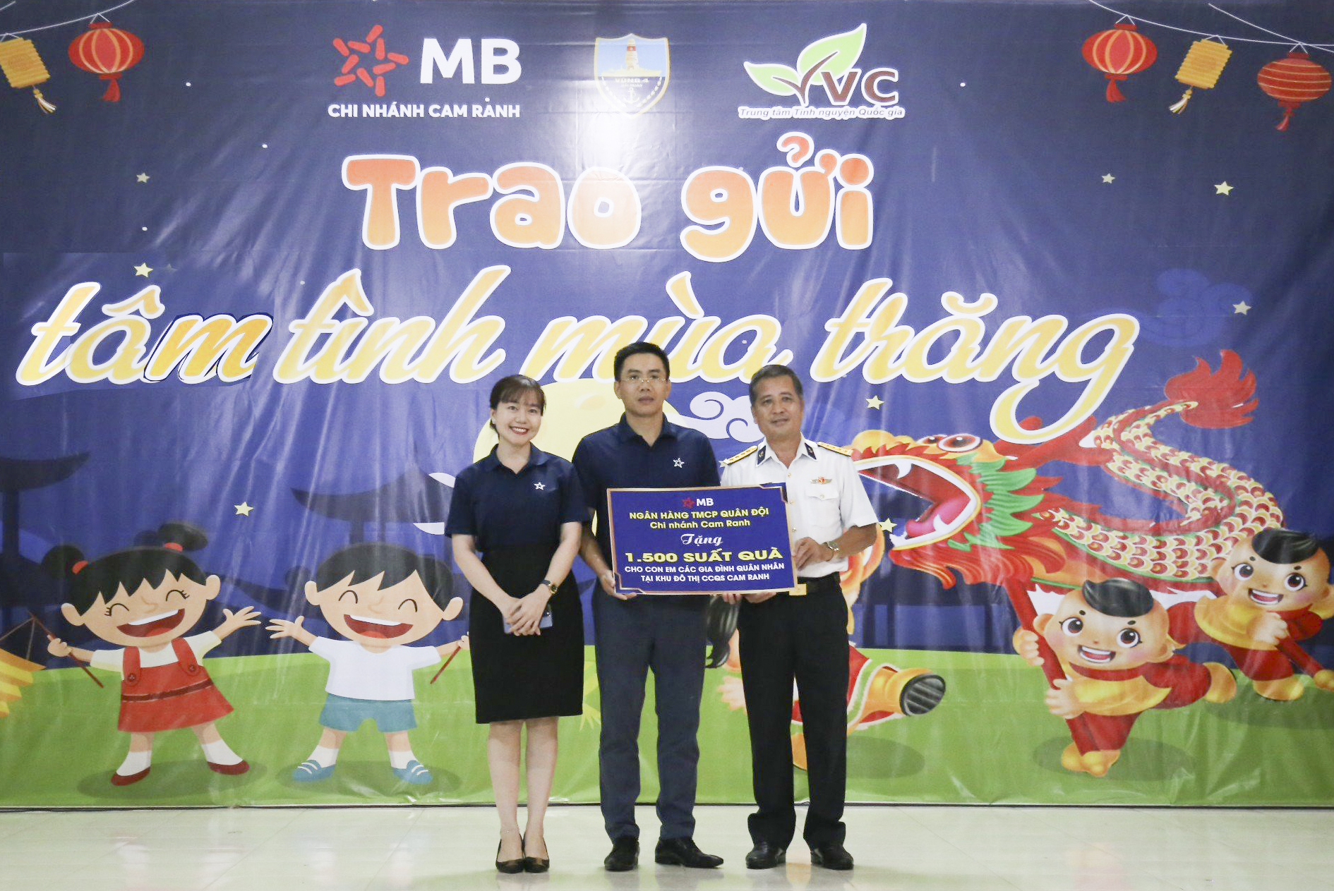 Đại diện Ngân hàng TMCP Quân đội (MB) Chi nhánh Cam Ranh trao bảng tượng trưng tặng 1.500 suất quà cho các cháu thiếu nhi.