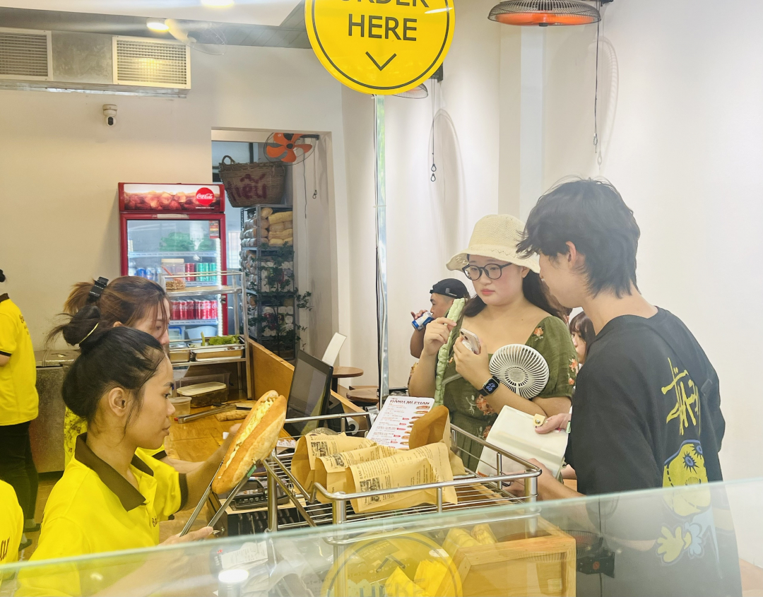 Korean tourists buy bread at Banh Mi Phan store