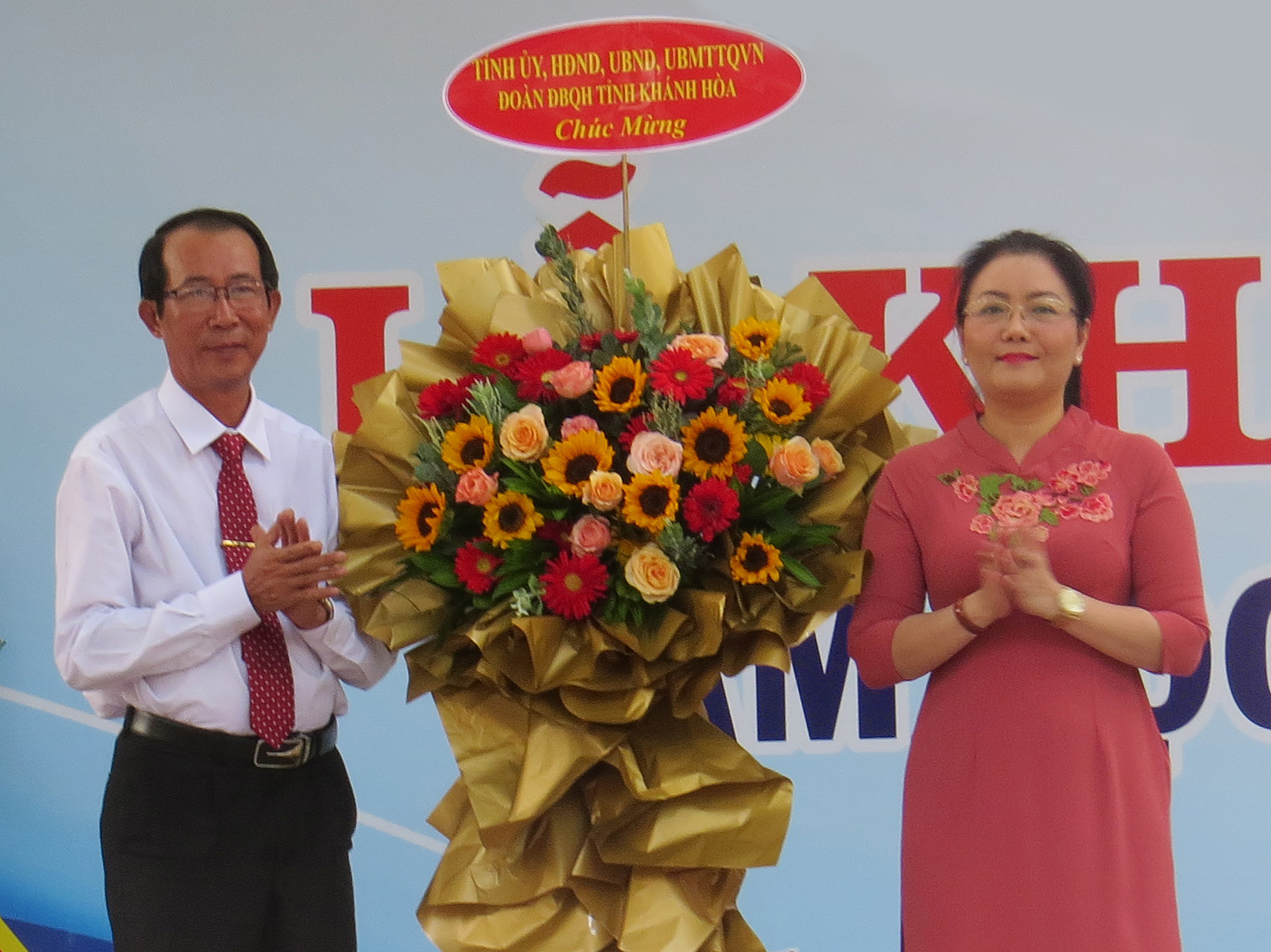 bà Phạm Thị Xuân Trang tặng hoa chúc mừng nhà trường
