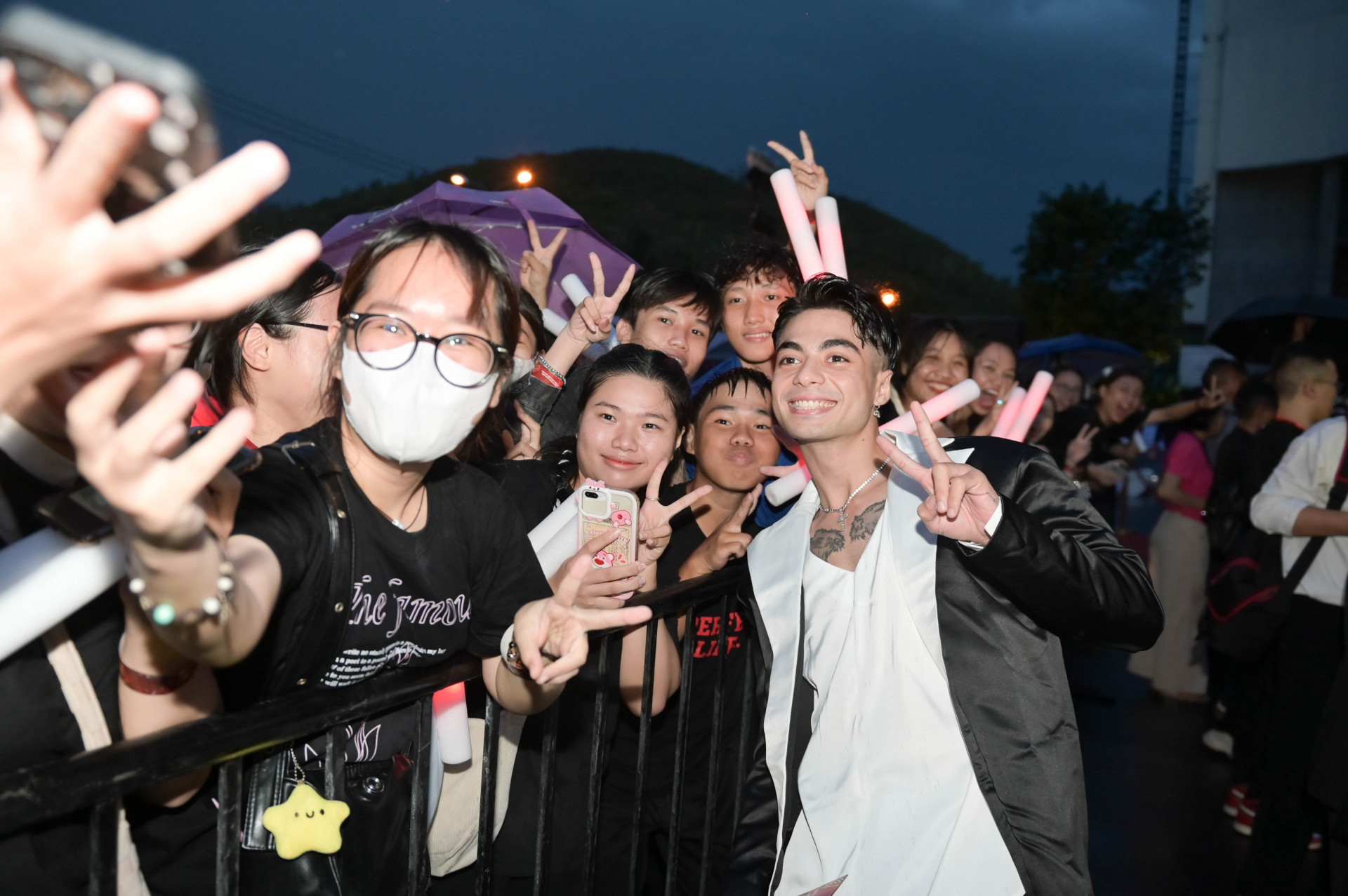 Artists posing for photo with audience

