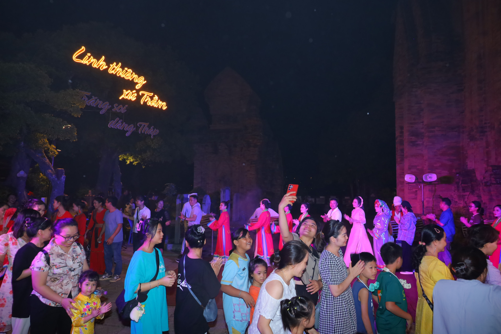 Local people and tourists experiencing a cultural activity at Ponagar Temple

