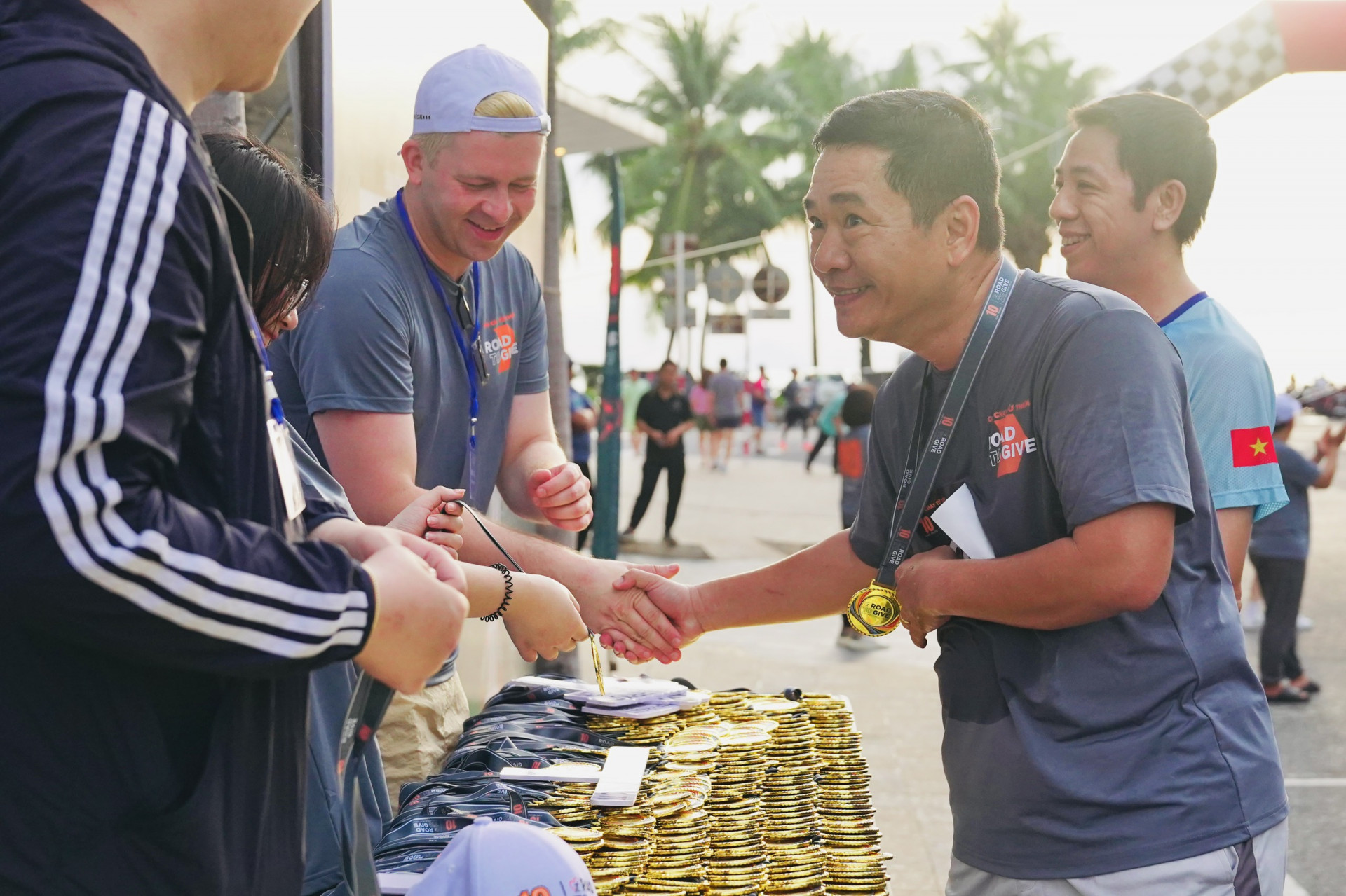 The organizers giving medals to the runners finishing the run

