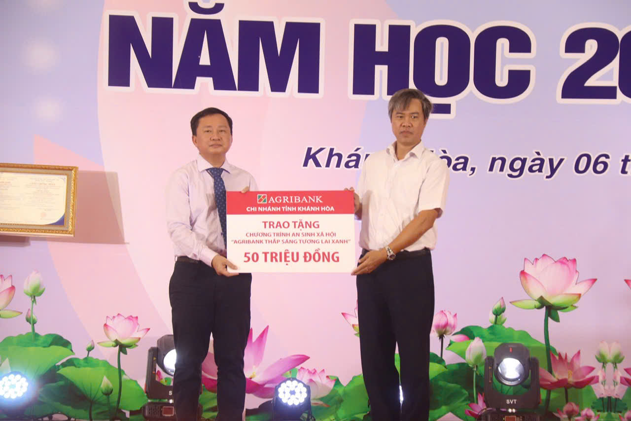 Ông Lê Anh Tuấn – Giám đốc Agribank Chi nhánh tỉnh Khánh Hòa (bìa phải) trao biểu trưng tài trợ cho lãnh đạo Trường Đại học Nha Trang.

