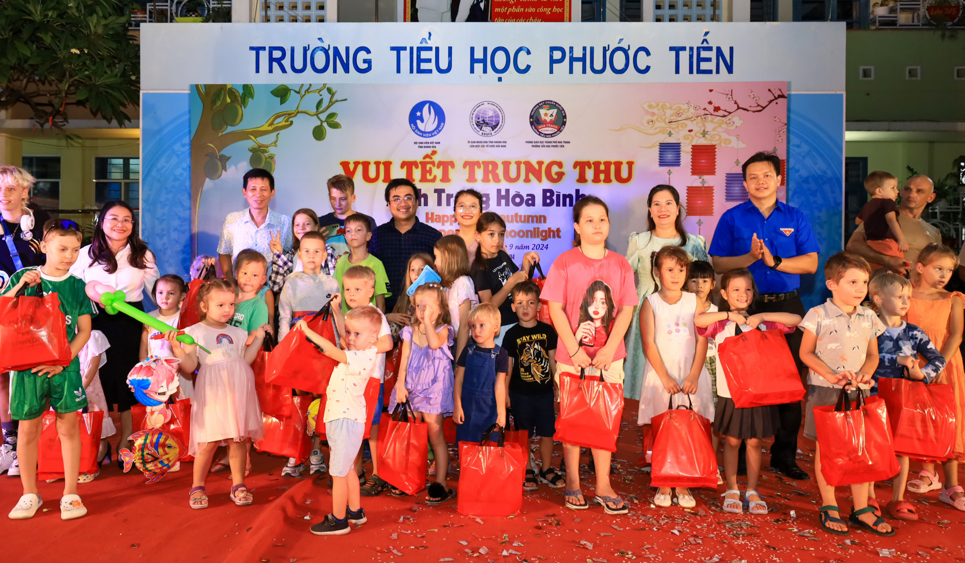 Đại diện các đơn vị tổ chức chương trình “Vui Tết trung thu - Ánh trăng hòa bình” tặng quà cho em thiếu nhi nước ngoài.