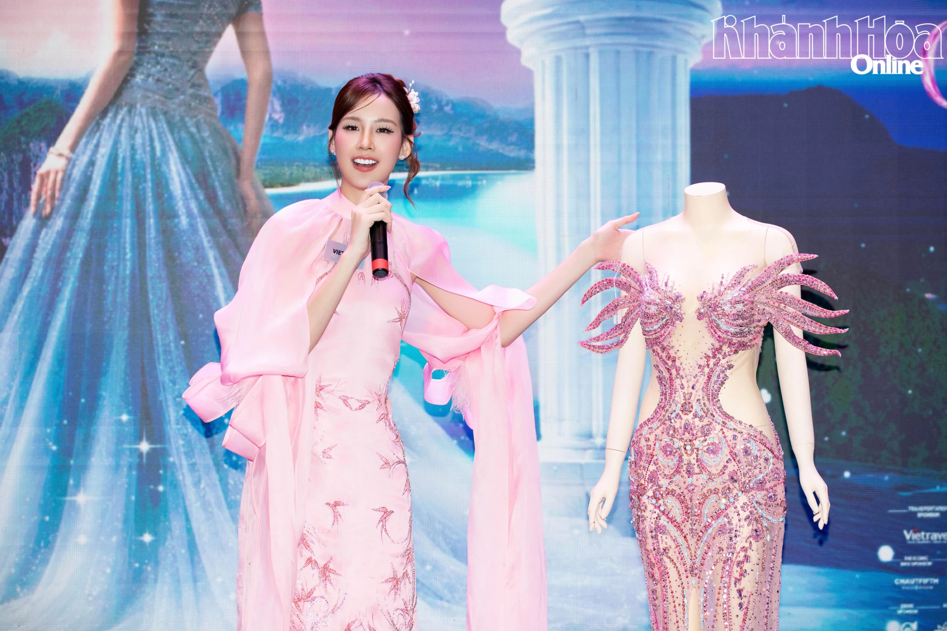 Le Nguyen Bao Ngoc presents an evening gown by designer Nguyen Minh Tuan at the charity auction

