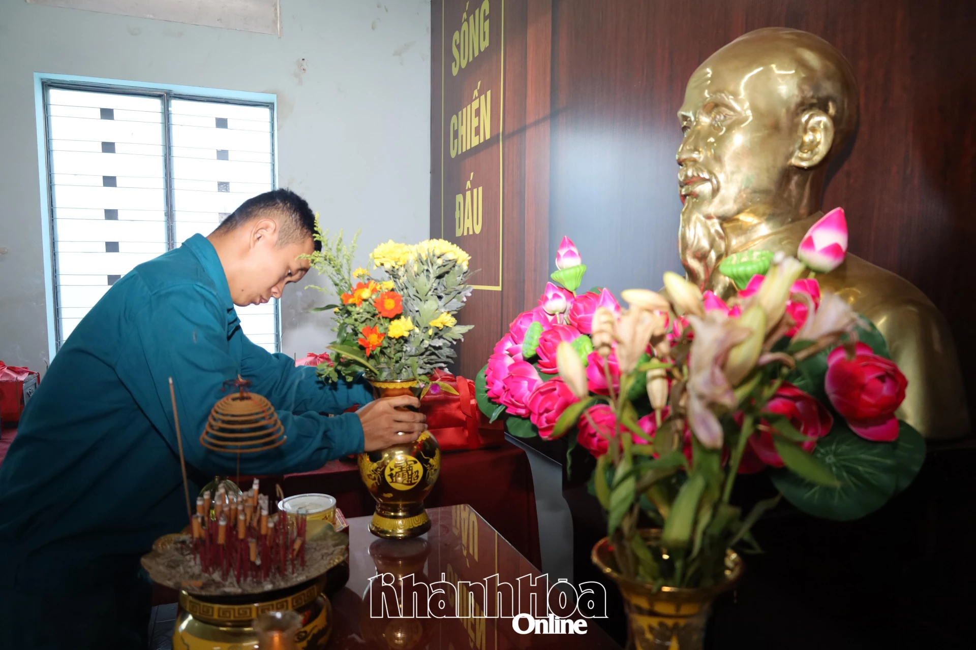 Anh cẩn thận đặt bình hoa mới lên ban thờ Bác Hồ trong phòng bảo quản hài cốt liệt sĩ.