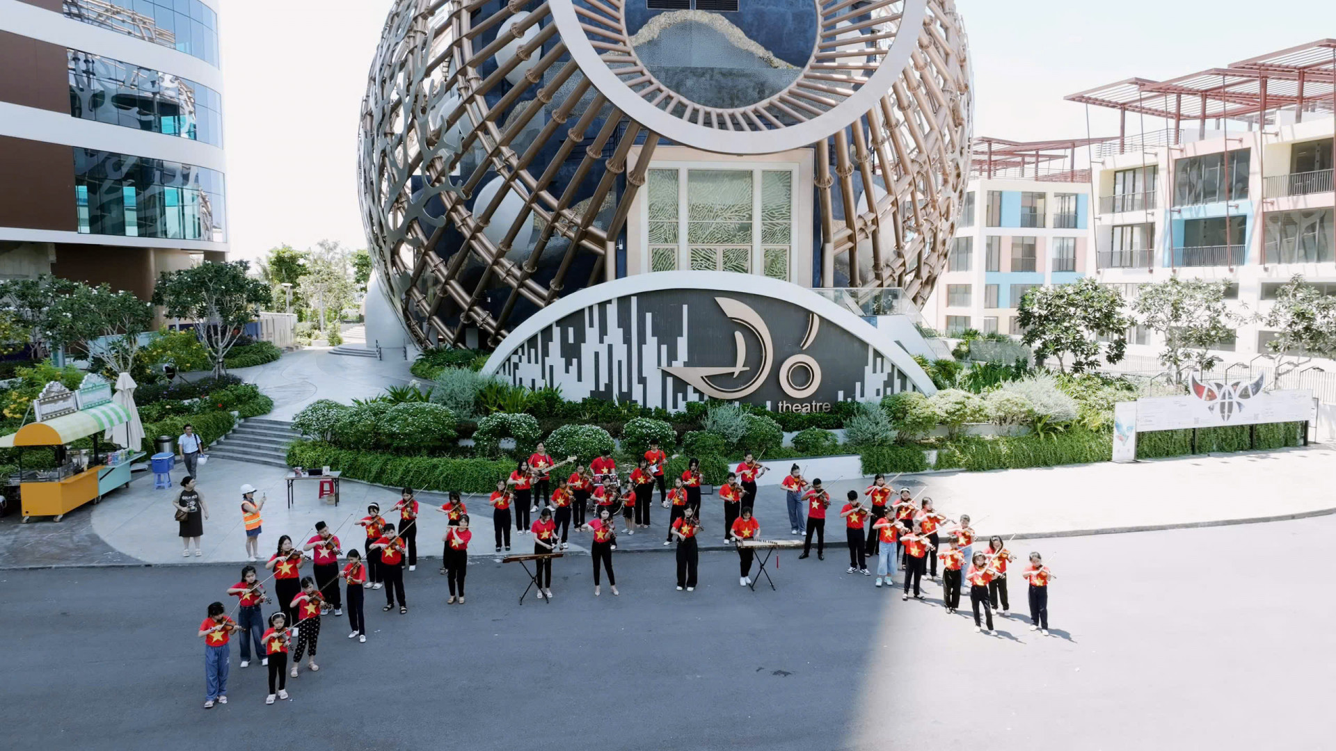 Arista Music Center students wearing national-flag T-shirts performing at Do Theater

