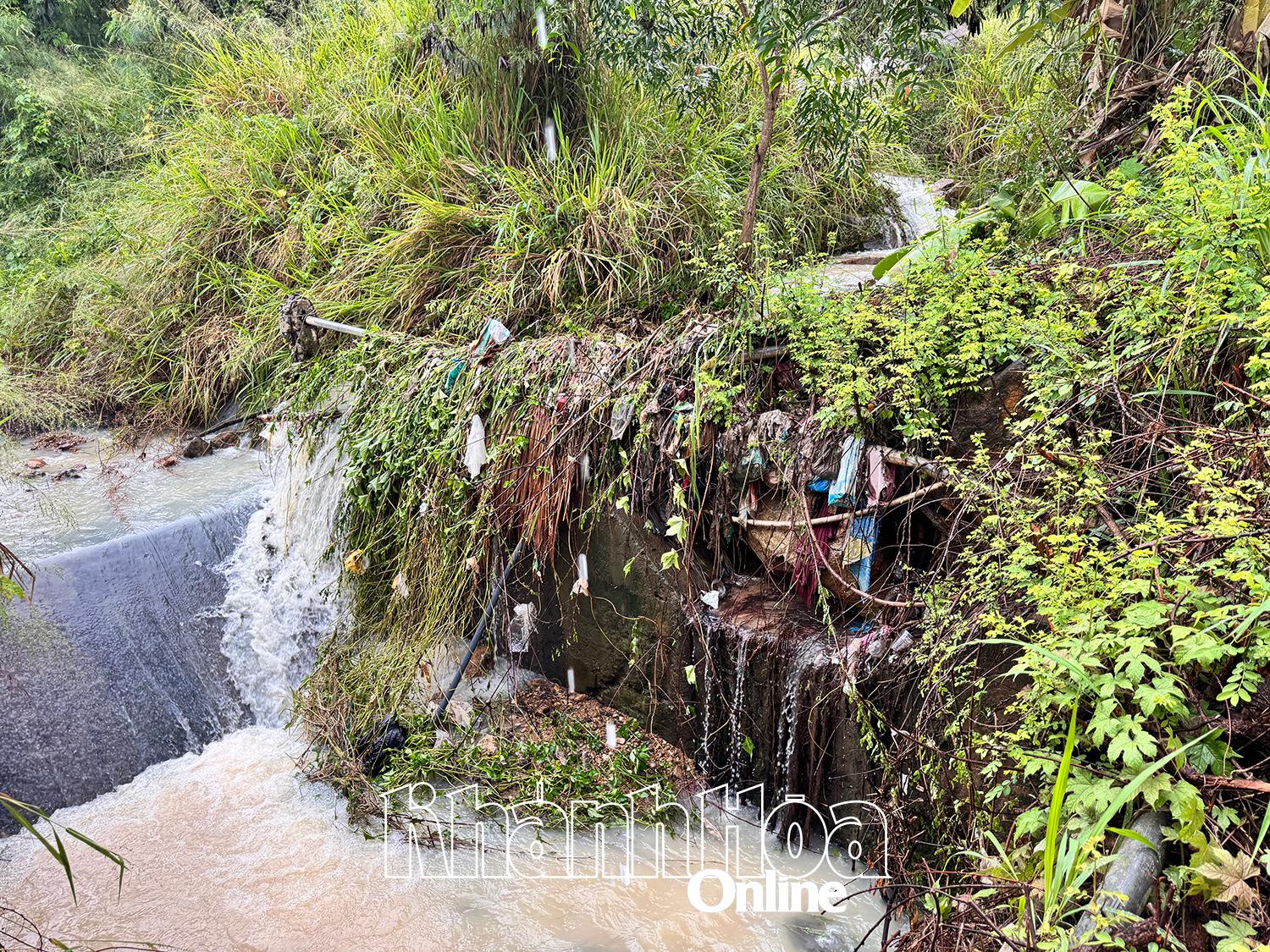 Nước từ trên núi chảy xuống khu vực dự án Haborizon Nha Trang bị vướng đá, cây, rác nên tràn ra mặt đường phía trước dự án.
