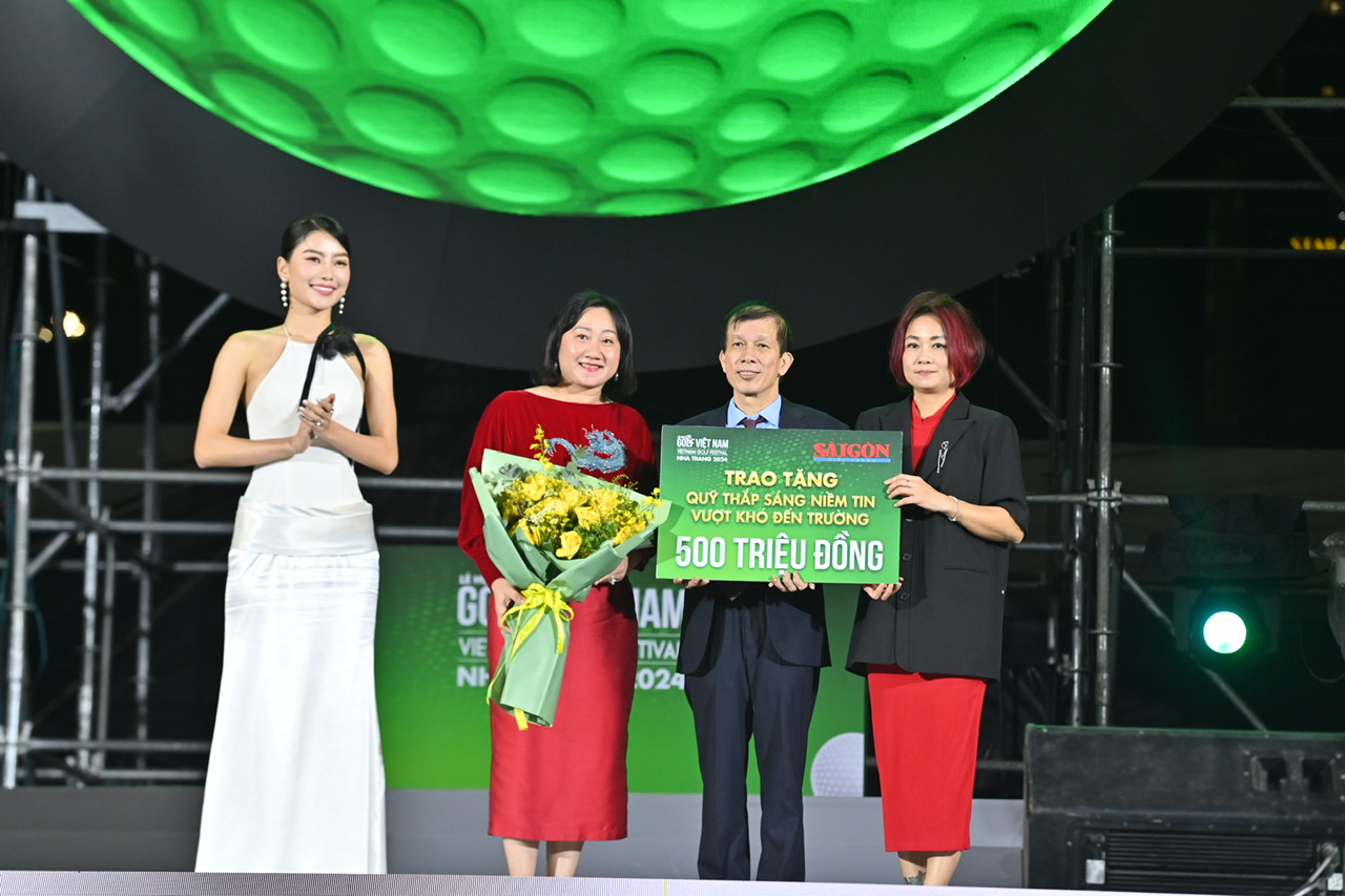 The representative of organizing committee presenting symbolic cheque of VND500 million to the scholarship fund of Saigon Giai Phong Newspaper

