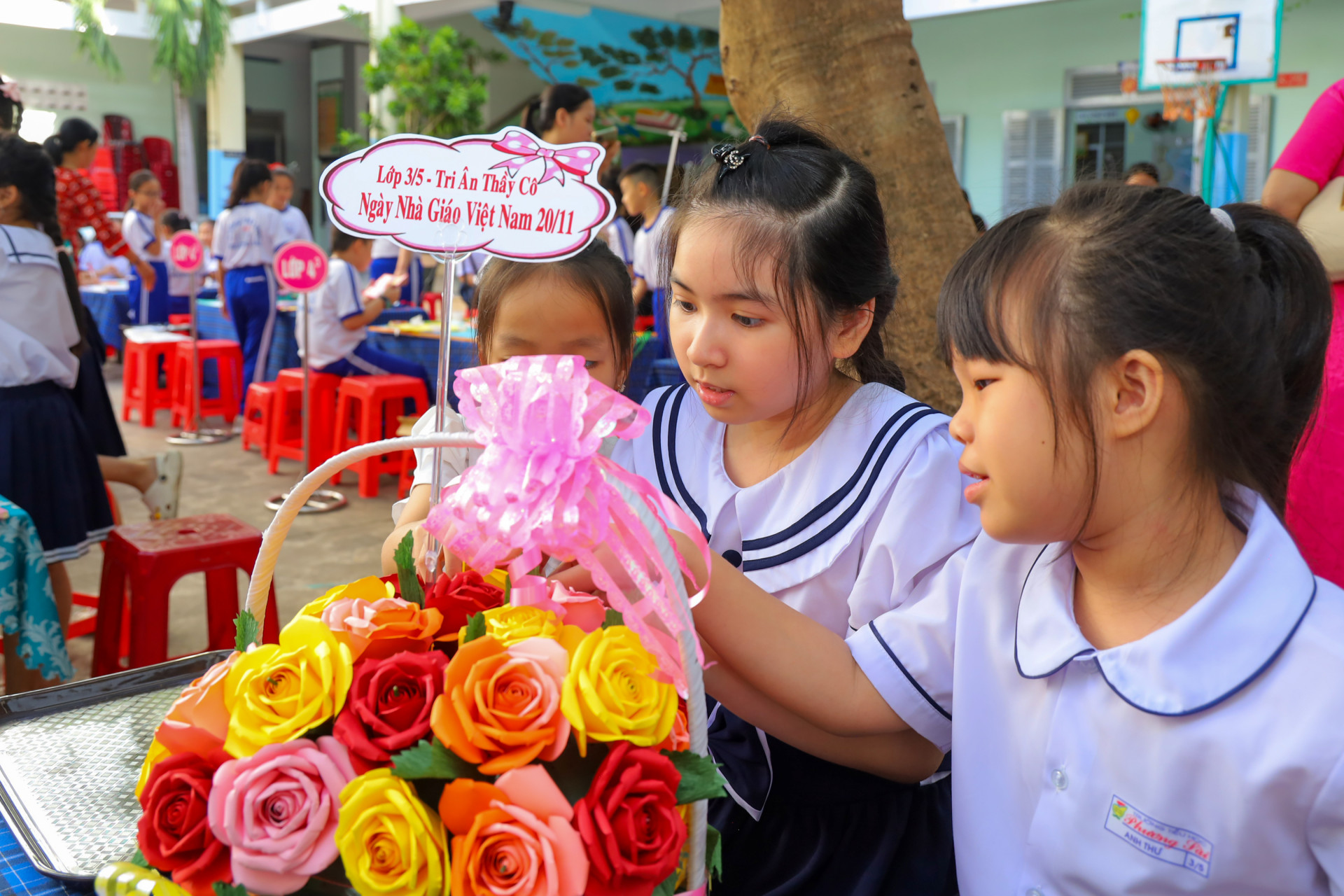 Các em học sinh lớp 3 chăm chút cho lẵng hoa dự thi.