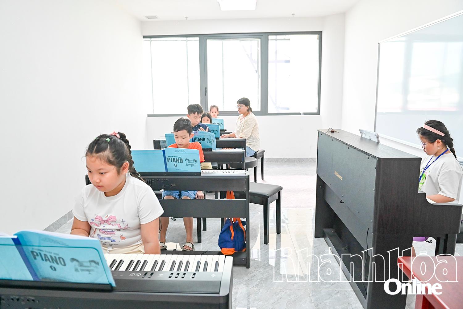 Children learning the piano at Khanh Hoa Childrens Cultural Palace

