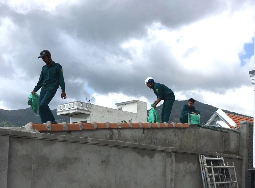 Huy động lực lượng giúp dân chằng chống nhà cửa.