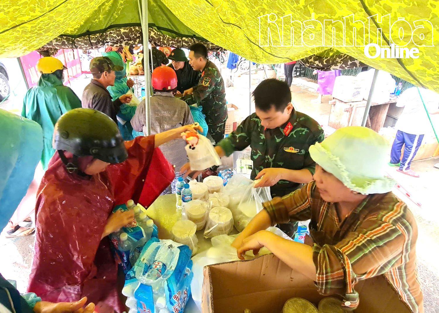 Người dân xã Diên Khánh nhận nhu yếu phẩm tại trạm cứu trợ trên địa bàn xã.