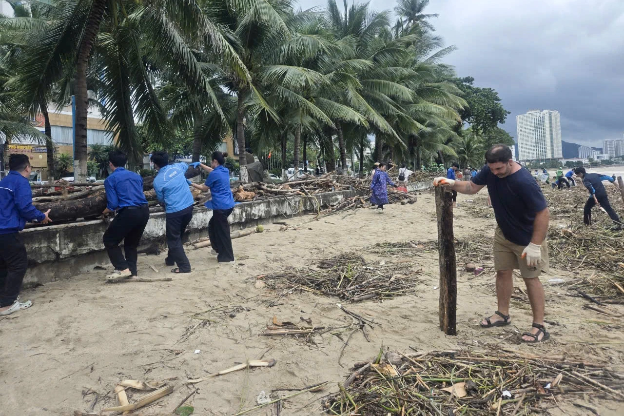Some foreign people cleaning up Nha Trang beach
